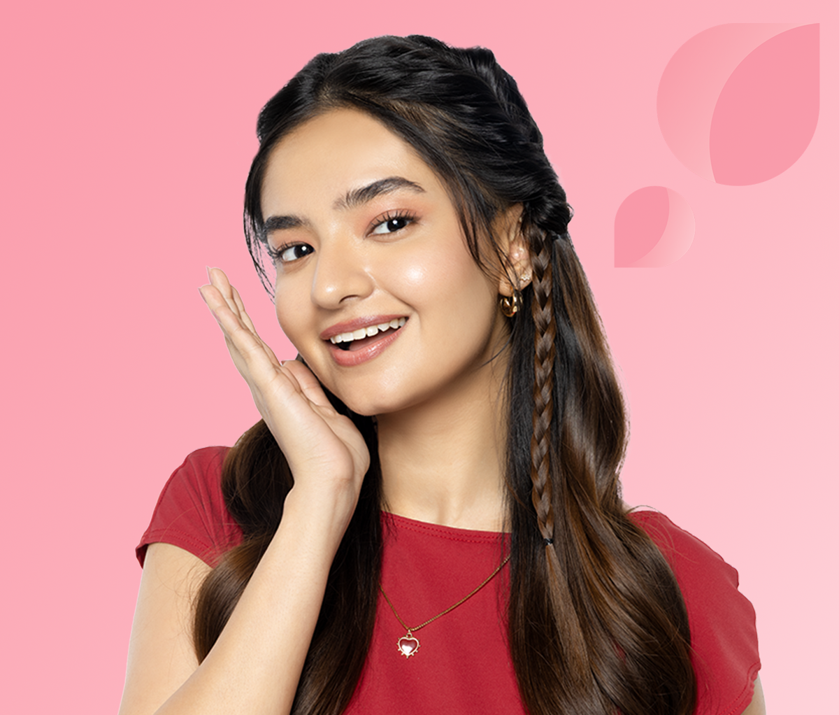 Woman wearing a red top against a pink background