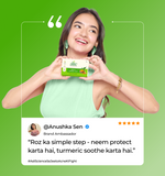 Woman holding a alite neem and turmeric soap  
