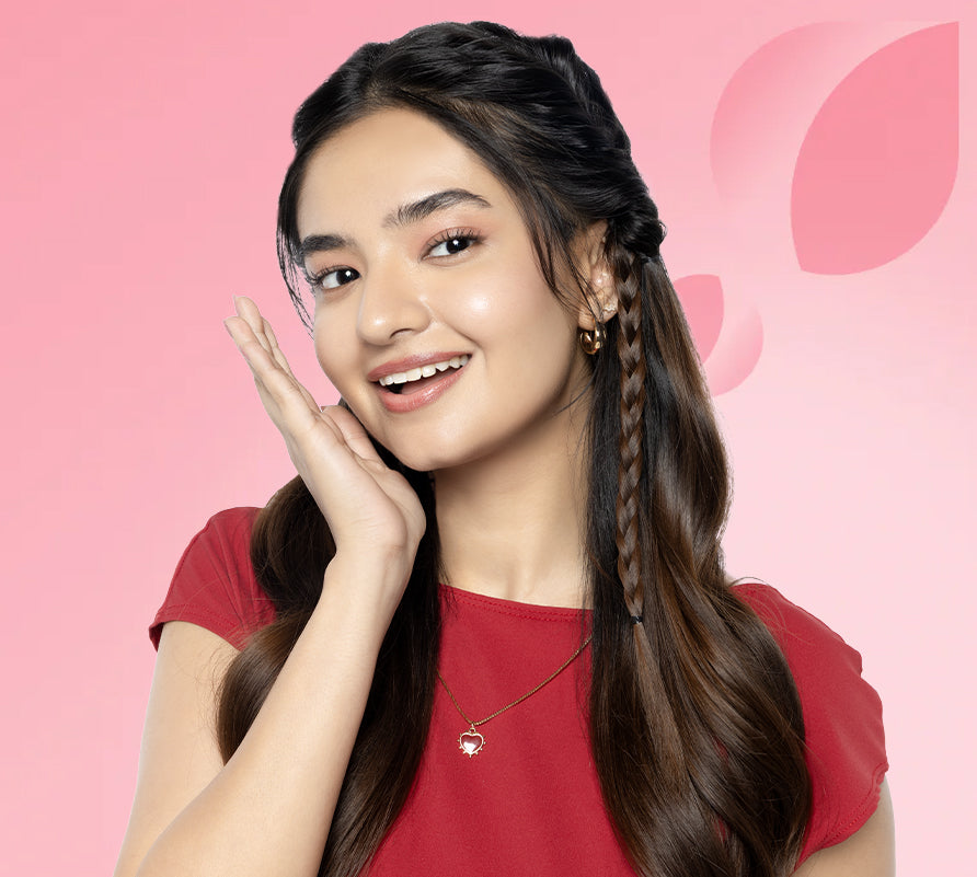 Woman wearing a red shirt against a pink background